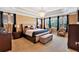 Luxurious main bedroom with tray ceiling, chandelier, large windows, and sitting area at 3819 Courson St, Marietta, GA 30066