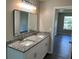 Bathroom with double vanity, granite countertop, modern mirror, and stylish fixtures at 433 Rhett Dr, Loganville, GA 30052