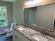 Bathroom featuring a granite countertop, modern lighting, and a large mirror at 433 Rhett Dr, Loganville, GA 30052