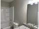 This bathroom includes a shower and tub combination, granite countertops, a sink, and a commode at 433 Rhett Dr, Loganville, GA 30052