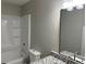 Bathroom featuring a granite countertop, modern lighting, and a bathtub at 433 Rhett Dr, Loganville, GA 30052