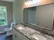Bathroom with granite countertops, dual vanity, and a large mirror, offering plenty of counter space at 433 Rhett Dr, Loganville, GA 30052