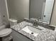 Bathroom featuring a granite countertop, modern lighting, and a bathtub at 433 Rhett Dr, Loganville, GA 30052