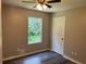 Bedroom with wood floors, a ceiling fan, and a sunlit window at 433 Rhett Dr, Loganville, GA 30052
