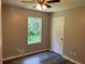 This bedroom features hardwood floors, a ceiling fan, and a window for natural lighting at 433 Rhett Dr, Loganville, GA 30052