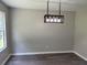 Dining room featuring modern light fixture and gray wood-look floors at 433 Rhett Dr, Loganville, GA 30052