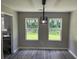 Well-lit dining room featuring modern light fixture and views of the outdoors at 433 Rhett Dr, Loganville, GA 30052