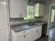 Stylish kitchen with granite counters, stainless steel sink, and ample cabinet space at 433 Rhett Dr, Loganville, GA 30052
