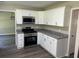 Modern kitchen featuring white cabinets, granite countertops, and stainless steel appliances at 433 Rhett Dr, Loganville, GA 30052