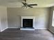 Inviting living room with a cozy fireplace, ceiling fan, and modern flooring at 433 Rhett Dr, Loganville, GA 30052