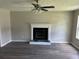 Inviting living room featuring a fireplace, ceiling fan, and modern flooring at 433 Rhett Dr, Loganville, GA 30052