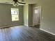 Spacious living room featuring wood floors, neutral paint, and bright windows at 433 Rhett Dr, Loganville, GA 30052