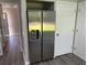 Pantry with stainless steel refrigerator and stylish gray wood-look floors at 433 Rhett Dr, Loganville, GA 30052