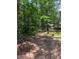 Located on a lush lot is a red barn with a gray roof at 6394 Shore Dr, Douglasville, GA 30135