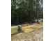 A unique property with a manufactured home and hay bale terracing amidst lush greenery at 6394 Shore Dr, Douglasville, GA 30135