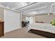 A partially finished basement with a bedroom, dining table and exposed ceiling at 1313 Fallsbrook Nw Ter, Acworth, GA 30101