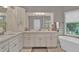 Elegant bathroom featuring a soaking tub, glass shower, and dual vanity at 1313 Fallsbrook Nw Ter, Acworth, GA 30101