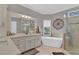 Elegant bathroom featuring a soaking tub, glass shower, and dual vanity at 1313 Fallsbrook Nw Ter, Acworth, GA 30101