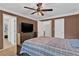 Bedroom with a plaid bedspread, ceiling fan, and view into an ensuite bathroom at 1313 Fallsbrook Nw Ter, Acworth, GA 30101