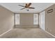 An empty bedroom with two windows, neutral walls, and carpeted floors at 1313 Fallsbrook Nw Ter, Acworth, GA 30101
