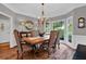 Elegant dining room featuring hardwood floors, bay windows, and chandelier at 1313 Fallsbrook Nw Ter, Acworth, GA 30101