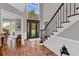 Grand foyer with hardwood floors, staircase, and large windows, creating a bright and inviting entrance at 1313 Fallsbrook Nw Ter, Acworth, GA 30101