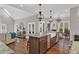 Spacious kitchen featuring a large island, hardwood floors, modern lighting, and open layout at 1313 Fallsbrook Nw Ter, Acworth, GA 30101