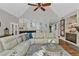 Inviting living room featuring vaulted ceilings, a cozy fireplace, and seamless flow to the kitchen at 1313 Fallsbrook Nw Ter, Acworth, GA 30101