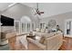 Bright living room with a cathedral ceiling, hardwood floors, and a comfortable sectional sofa at 1313 Fallsbrook Nw Ter, Acworth, GA 30101