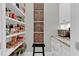 Organized pantry with shelves, countertops, and a microwave at 1313 Fallsbrook Nw Ter, Acworth, GA 30101