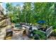 Relaxing outdoor deck with a grill, a hot tub, a lounge area, an umbrella table, and forest views at 1313 Fallsbrook Nw Ter, Acworth, GA 30101