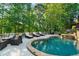 A beautiful backyard swimming pool and hot tub surrounded by lush landscaping and mature trees at 1313 Fallsbrook Nw Ter, Acworth, GA 30101