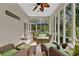 Screened porch featuring wicker furniture and a ceiling fan at 1313 Fallsbrook Nw Ter, Acworth, GA 30101