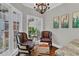 Inviting sitting area with hardwood floors, leather chairs, and natural light from the window at 1313 Fallsbrook Nw Ter, Acworth, GA 30101