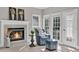 Cozy sitting room with a fireplace, comfortable chair, and plenty of natural light at 1313 Fallsbrook Nw Ter, Acworth, GA 30101