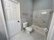This bathroom features tile flooring, a toilet, shower with marble surround, and a towel rack at 2268 Sparrow Ridge Ne Dr, Marietta, GA 30066