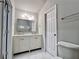 Bathroom with double sink vanity, toilet, and marble tile floor at 2268 Sparrow Ridge Ne Dr, Marietta, GA 30066