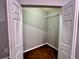 Empty walk-in closet with hardwood floors and white door at 2268 Sparrow Ridge Ne Dr, Marietta, GA 30066