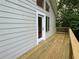 Side view of deck with wooden railing and siding and door accessing interior at 2268 Sparrow Ridge Ne Dr, Marietta, GA 30066