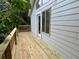Side view of wooden deck, railing and siding with leafy trees at 2268 Sparrow Ridge Ne Dr, Marietta, GA 30066