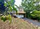 Exterior view of the home with a two-car garage, a balcony, and surrounded by trees at 2268 Sparrow Ridge Ne Dr, Marietta, GA 30066