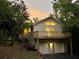 Charming two-story home with a large deck and two car garage nestled among mature trees at sunset at 2268 Sparrow Ridge Ne Dr, Marietta, GA 30066