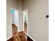 This hallway features hardwood floors, gray walls, white trim, and two doorways at 2268 Sparrow Ridge Ne Dr, Marietta, GA 30066