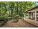 View of the exterior screened-in porch and wooded backyard at 4968 Twin Branches Way, Dunwoody, GA 30338
