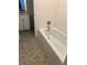 Bathroom features white subway tile and a classic tub at 4968 Twin Branches Way, Dunwoody, GA 30338