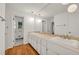 This bathroom features double sinks, a large vanity mirror, and great lighting at 4968 Twin Branches Way, Dunwoody, GA 30338