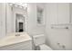 Bright bathroom featuring a single sink vanity, toilet, and built-in cabinet at 4968 Twin Branches Way, Dunwoody, GA 30338