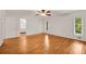Bedroom with hardwood floors, ceiling fan, and ample natural light from large windows at 4968 Twin Branches Way, Dunwoody, GA 30338