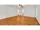 Expansive bedroom with ceiling fan and adjoining bathroom featuring a hardwood floor at 4968 Twin Branches Way, Dunwoody, GA 30338