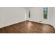Bright bedroom with wood floors, white walls, and two windows offering natural light at 4968 Twin Branches Way, Dunwoody, GA 30338